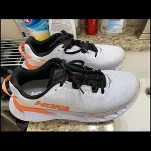 white and orange Hoka women’s shoes